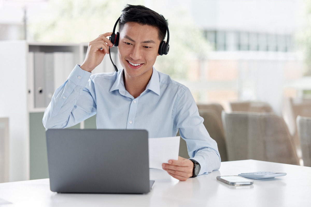 Man using laptop and wearing headphones