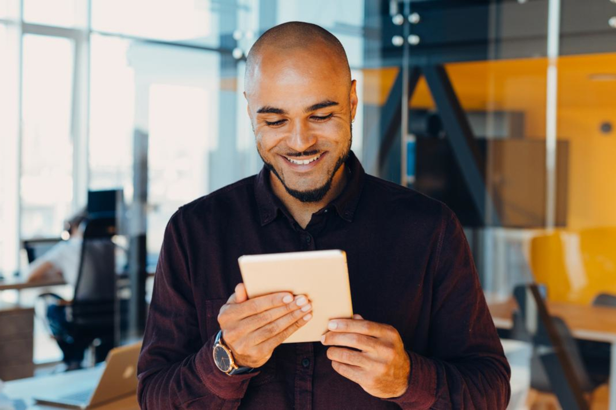 Smiling man looking at tablet