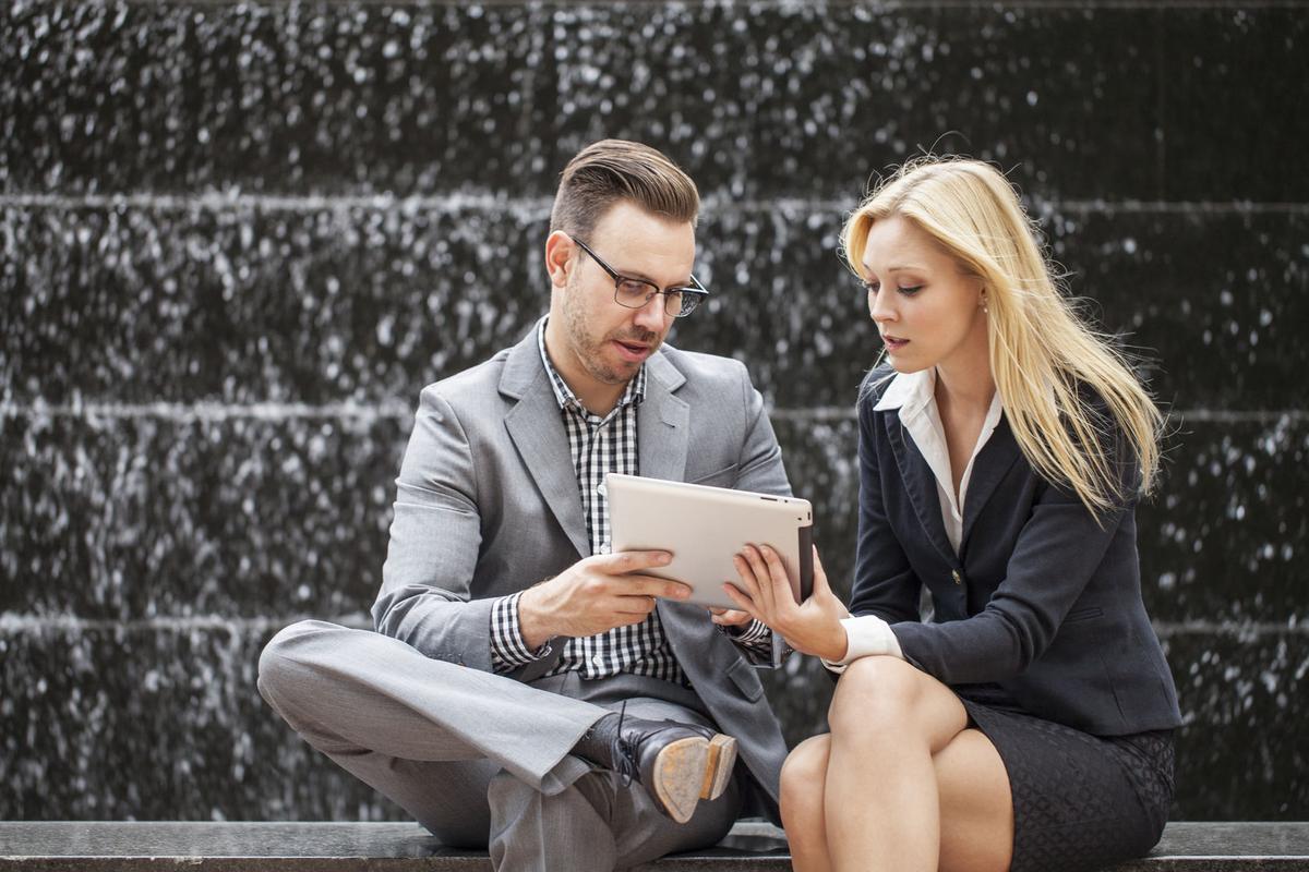 Two colleagues looking at phone